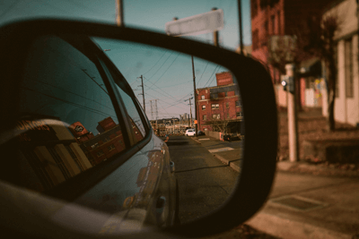 Vista da rua refletida no retrovisor, dicas de segurança